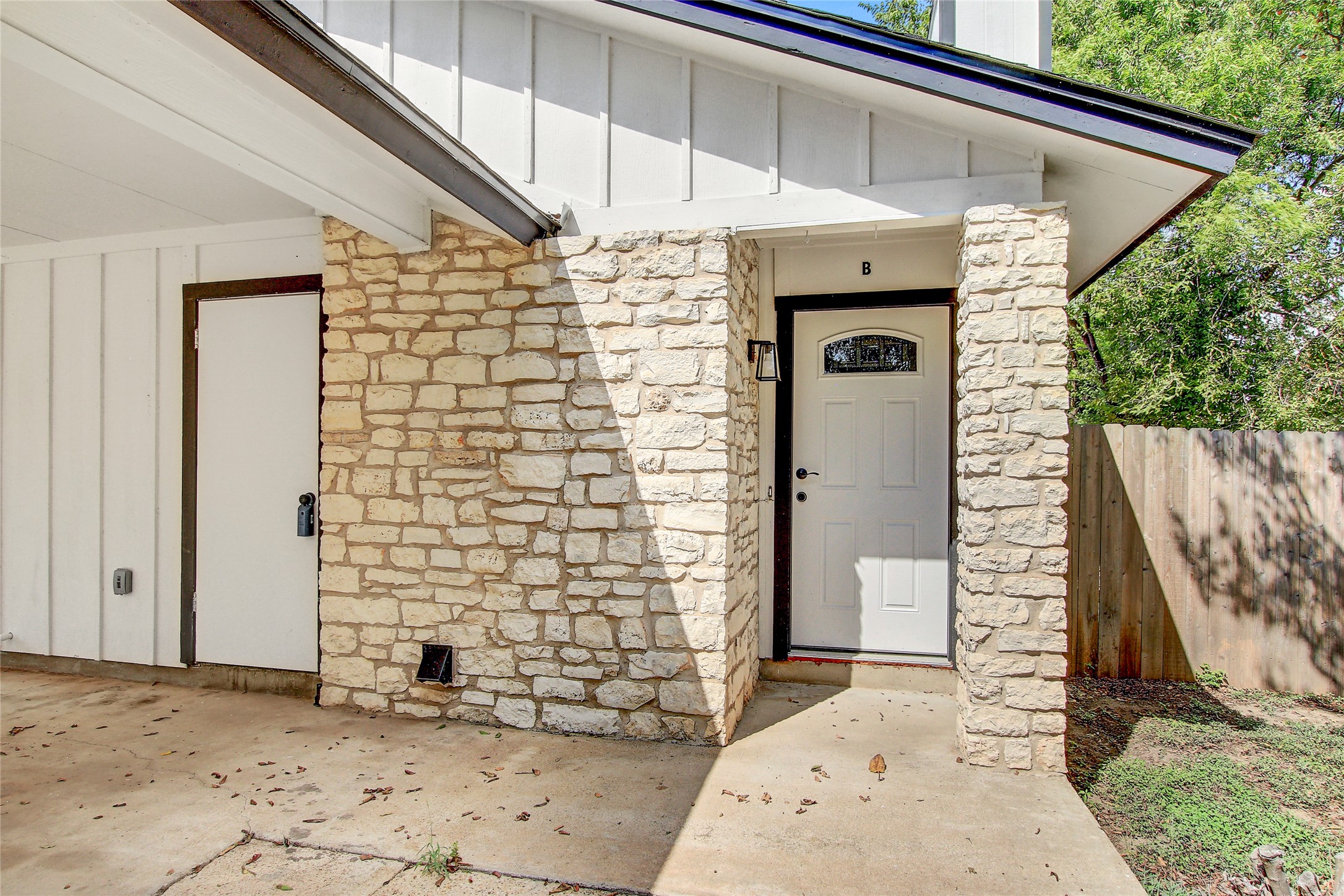 902 King Albert Street, Unit B Austin, TX 78745 - Photo 2 of 16 Entrance to property featuring board and batten siding and stone siding