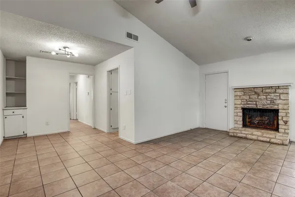 a view of an empty room with a fireplace