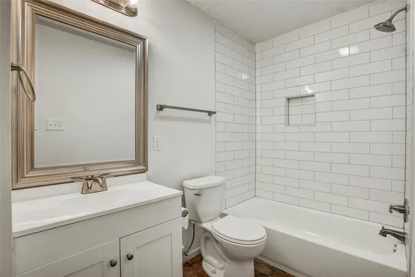 a bathroom with a sink mirror toilet and bathtub