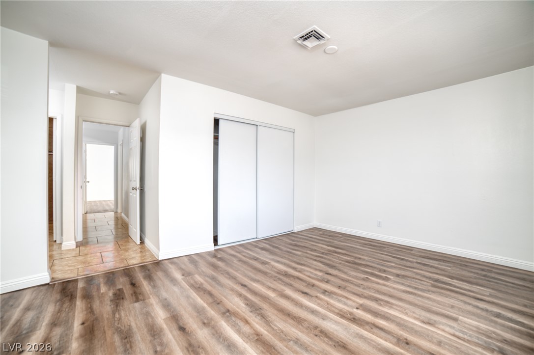 3556 Ruth Drive Las Vegas, NV 89121 - Photo 10 of 21 A quiet retreat, this bedroom offers ample space and warm wood-look flooring.