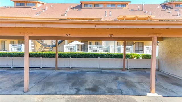 an aerial view of a swimming pool with outdoor seating