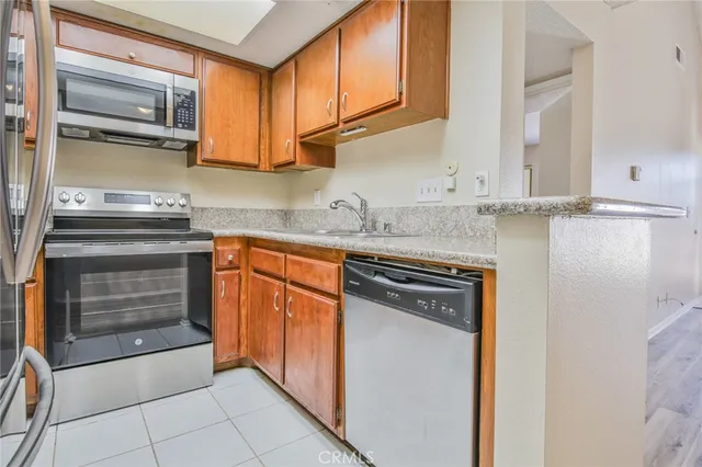 a kitchen with stainless steel appliances granite countertop a stove and cabinets