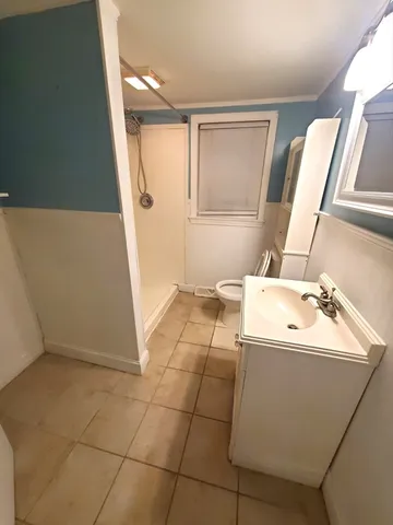 a bathroom with a sink a toilet and mirror