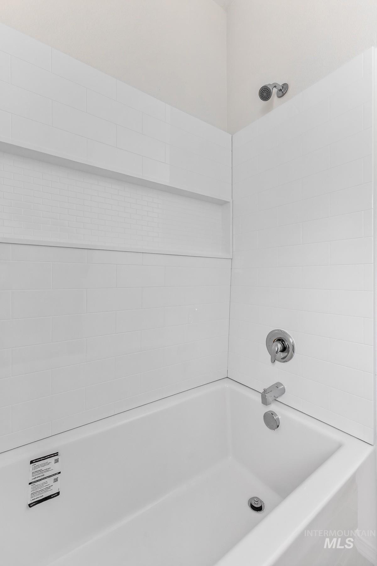 1649 Crown Point Parkway Cascade, ID 83611 - Photo 17 of 24 White subway tile shower surround with an integrated niche featuring mosaic tile