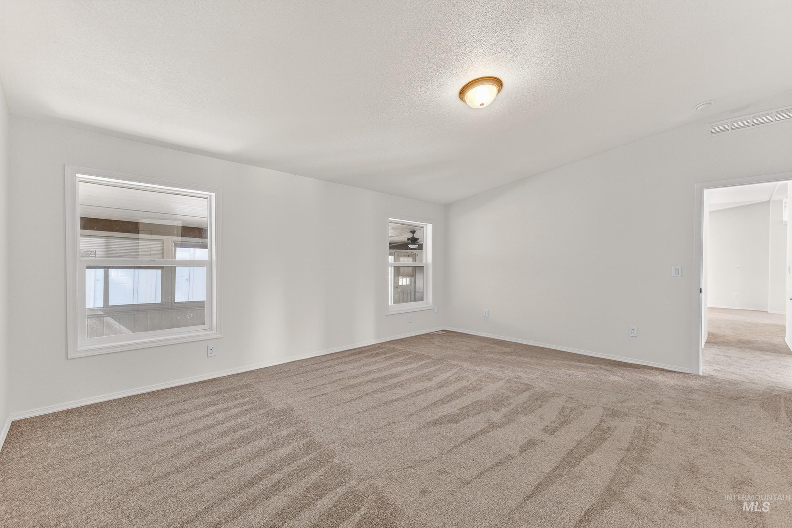 1649 Crown Point Parkway Cascade, ID 83611 - Photo 18 of 24 Spacious interior room featuring neutral-toned carpeting and white wall finishes