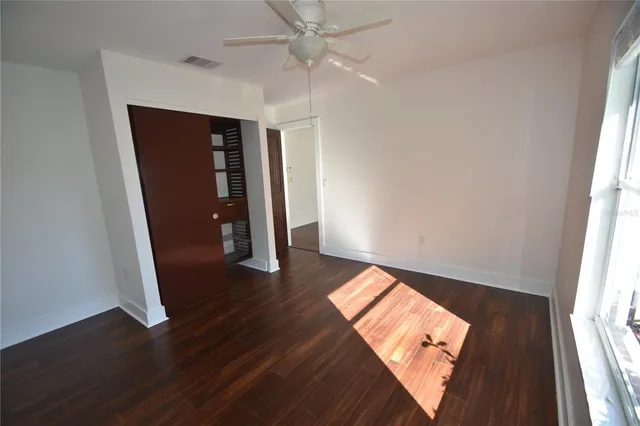 wooden floor in an empty room with a window