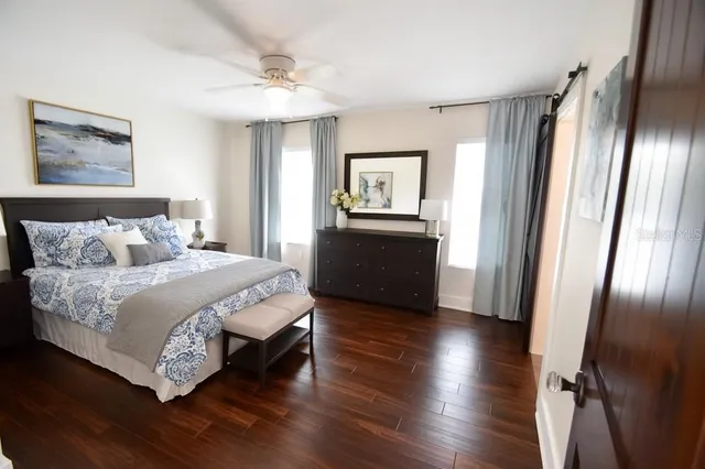 a bedroom with a bed and a chandelier