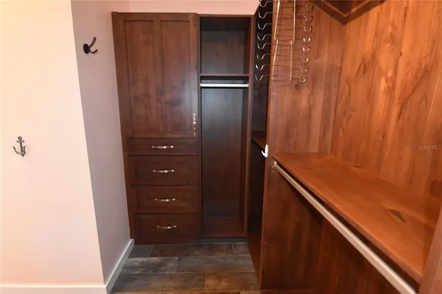 a large kitchen with a large counter top appliances and cabinets