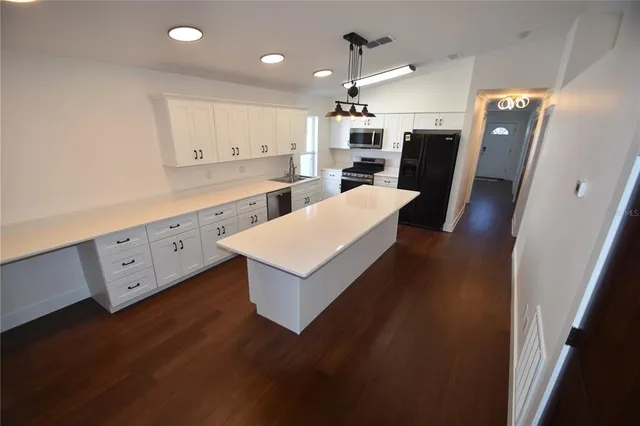 a large kitchen with a wooden floor and a large window