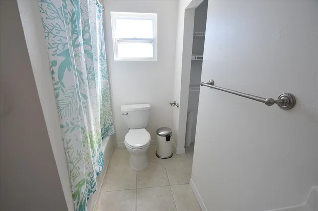 a view of a backyard with table and chairs under an umbrella