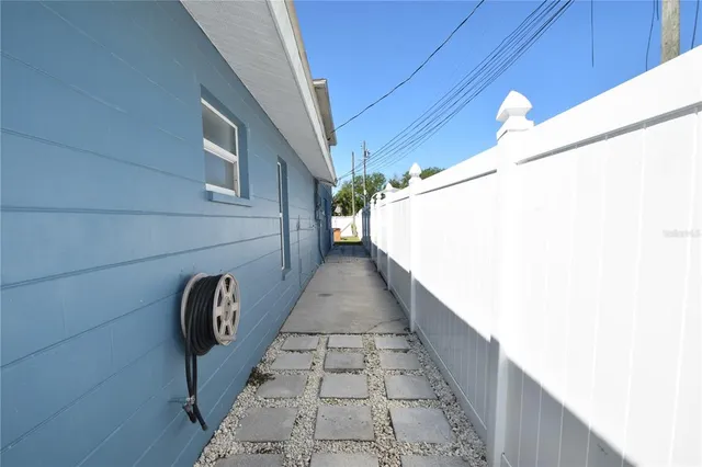 a view of a backyard with a table and chairs
