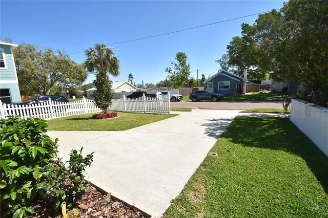 a view of a house with a yard and plants