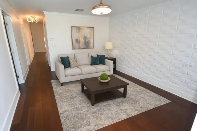 a living room with furniture and a rug