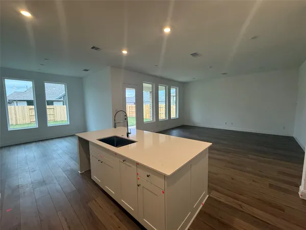 a kitchen with sink cabinets and wooden floor