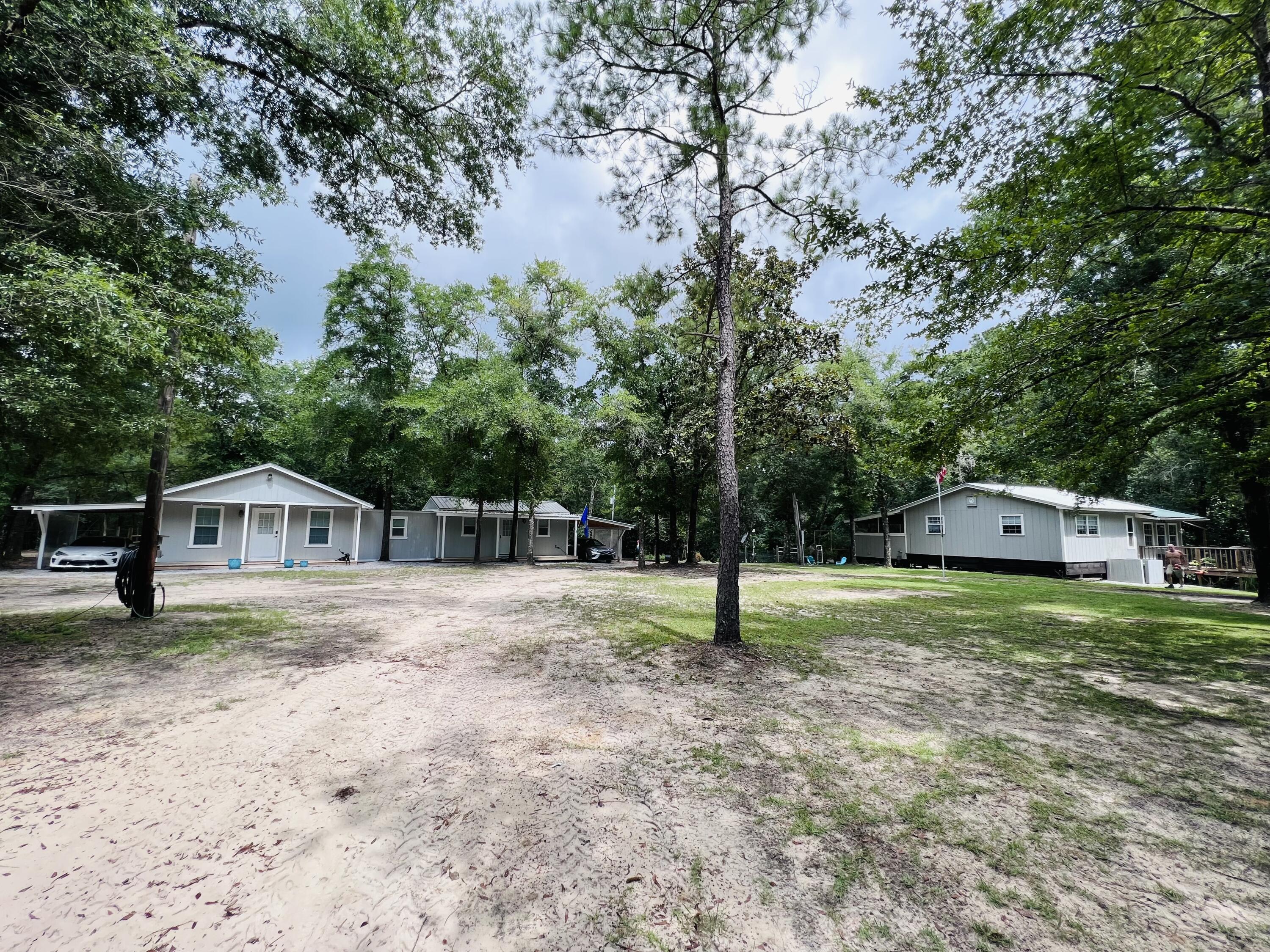 Xxxx Kervin Road Crestview, FL 32539 - Photo 28 of 78 a house with a big yard and large trees