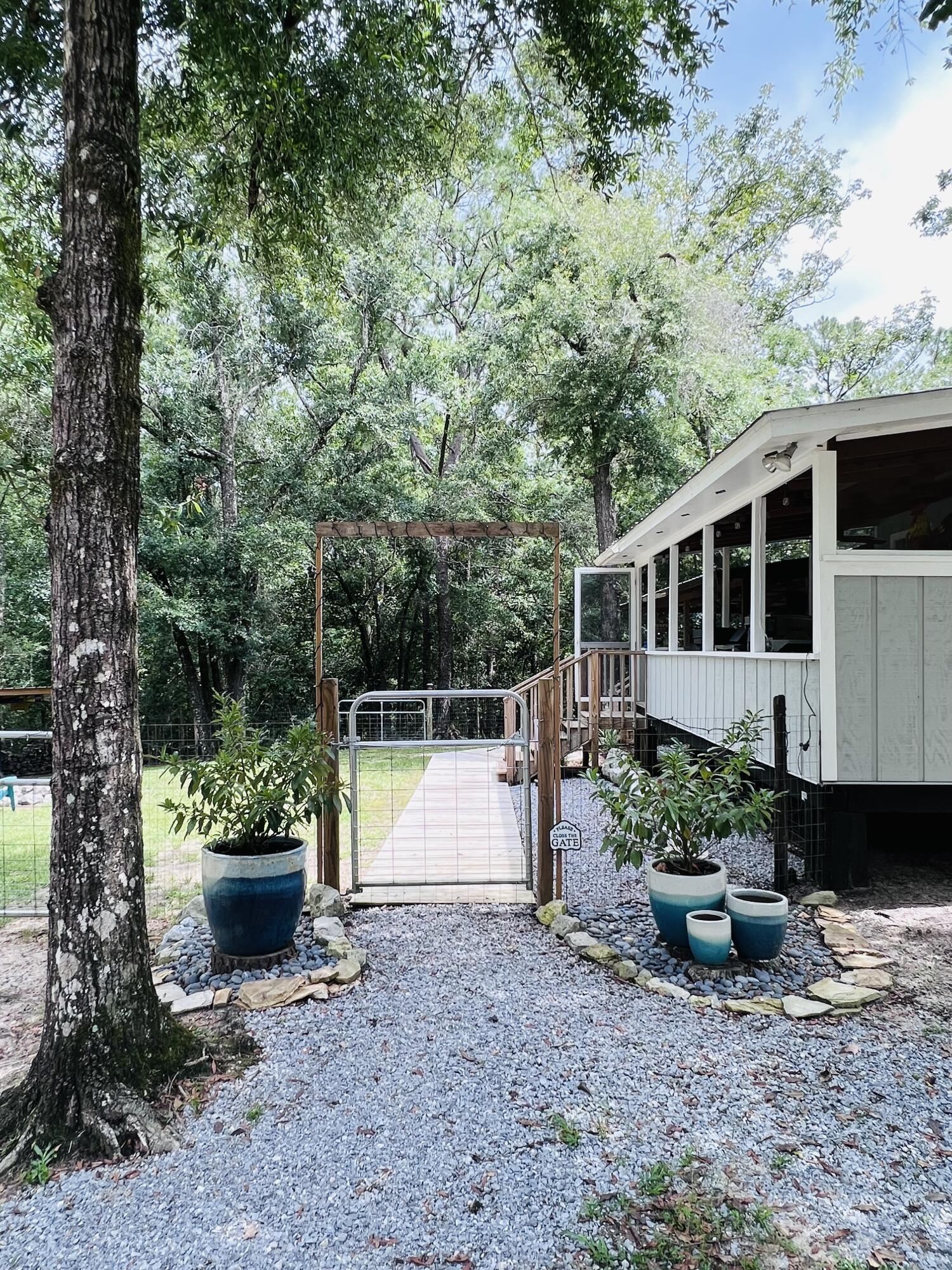 Xxxx Kervin Road Crestview, FL 32539 - Photo 32 of 78 a view of a chair and table in the backyard