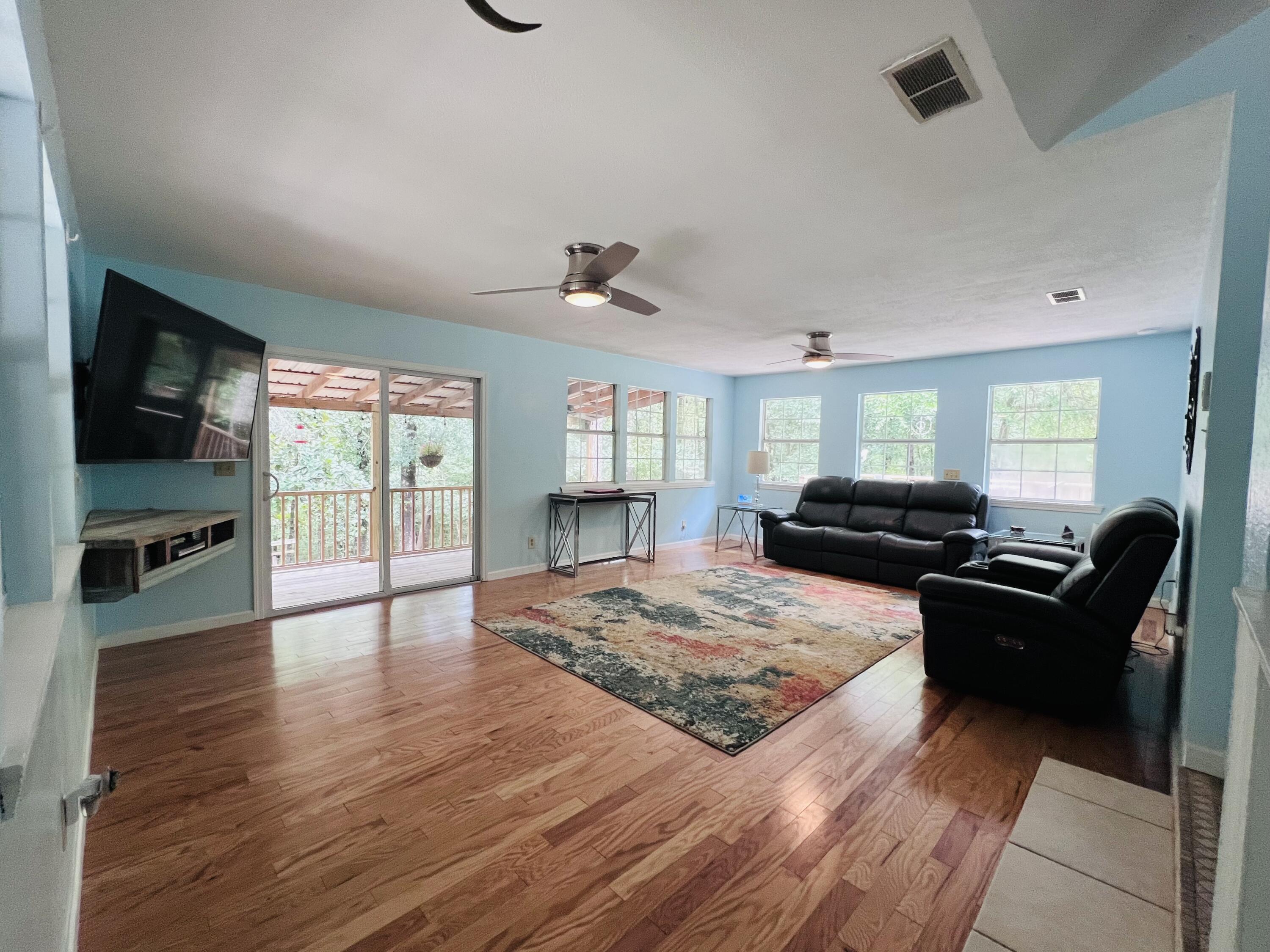 Xxxx Kervin Road Crestview, FL 32539 - Photo 34 of 78 a living room with furniture flat screen tv and wooden floor