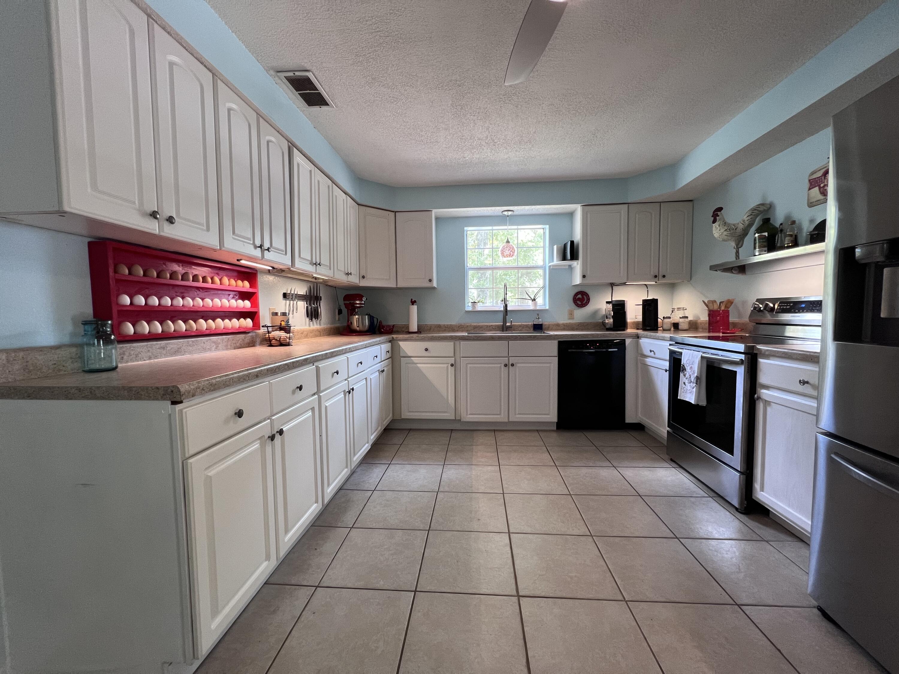 Xxxx Kervin Road Crestview, FL 32539 - Photo 39 of 78 a kitchen with stainless steel appliances granite countertop a sink counter space cabinetry and a window