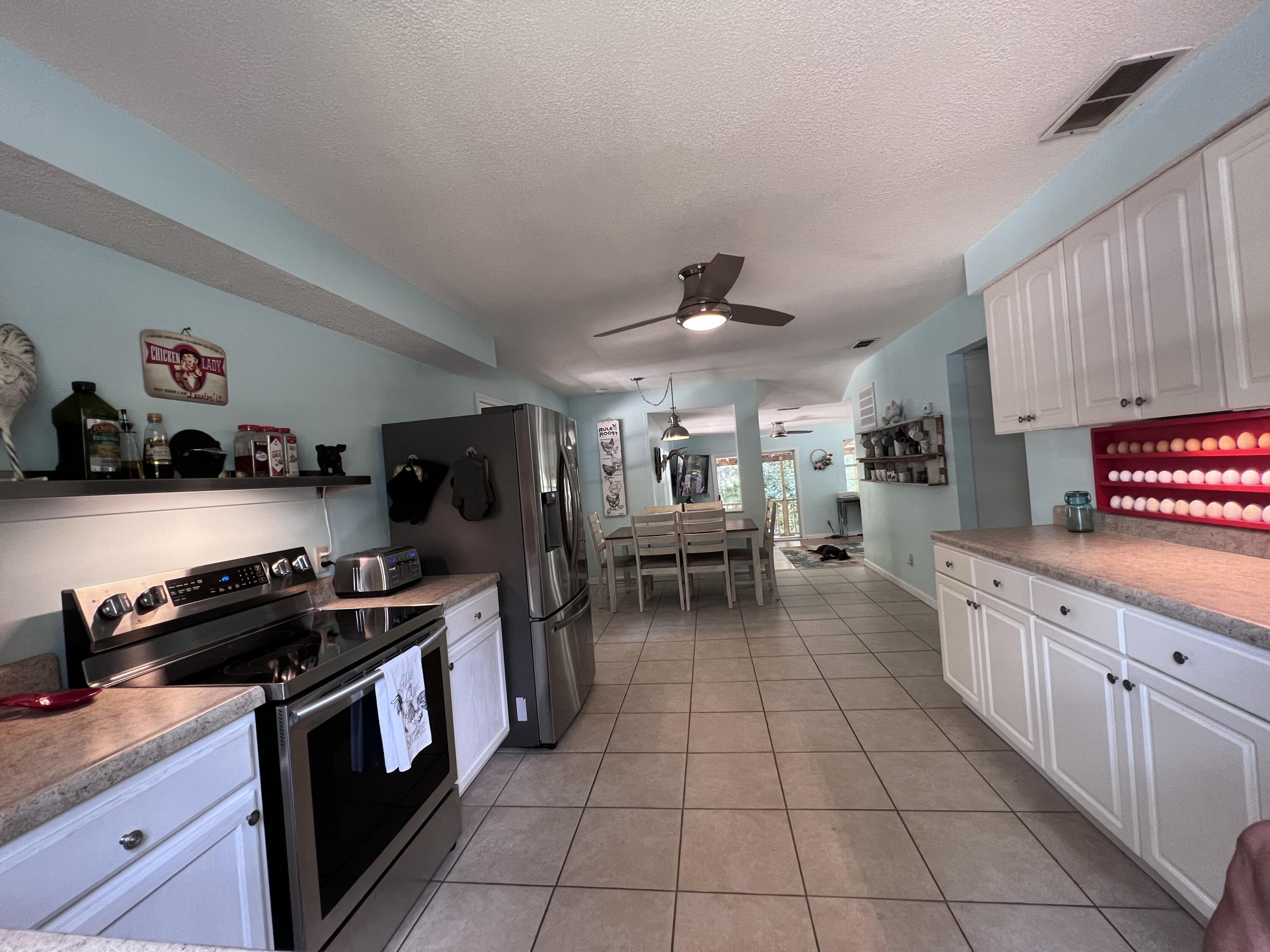 Xxxx Kervin Road Crestview, FL 32539 - Photo 40 of 78 a kitchen with stainless steel appliances a stove a sink and a refrigerator