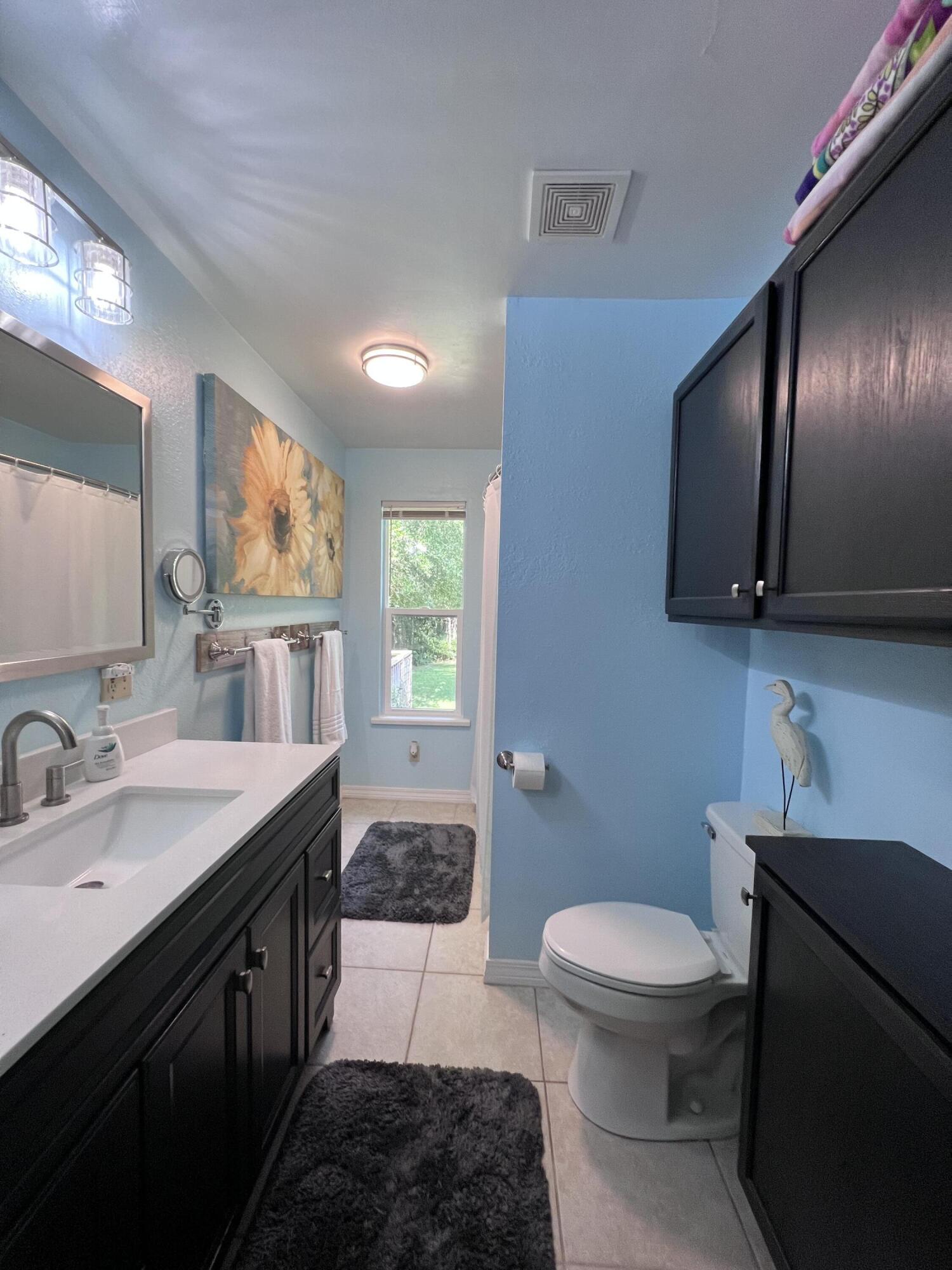 Xxxx Kervin Road Crestview, FL 32539 - Photo 45 of 78 a spacious bathroom with a toilet sink and mirror