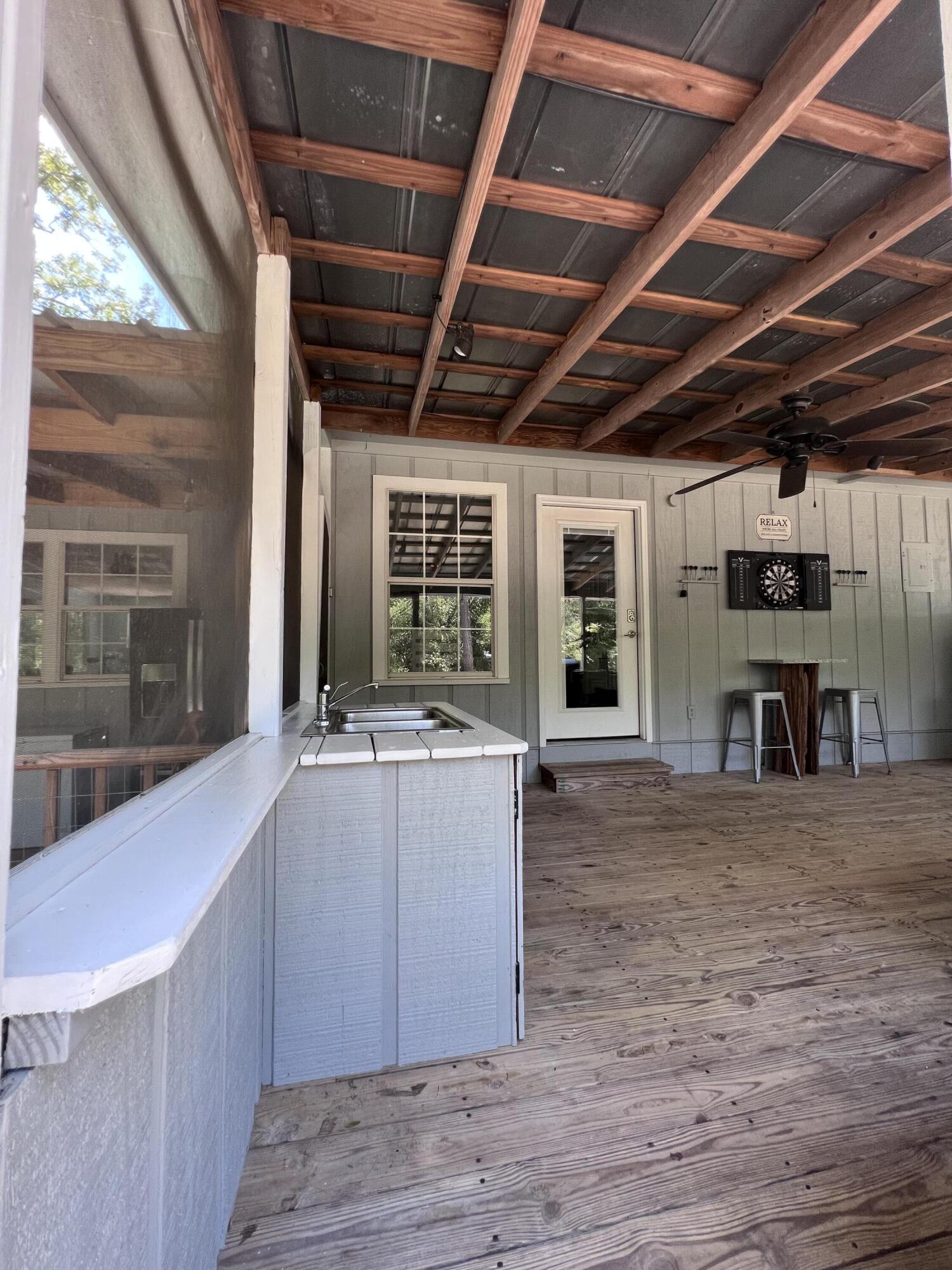 Xxxx Kervin Road Crestview, FL 32539 - Photo 46 of 78 a view of an empty room with wooden floor and a window
