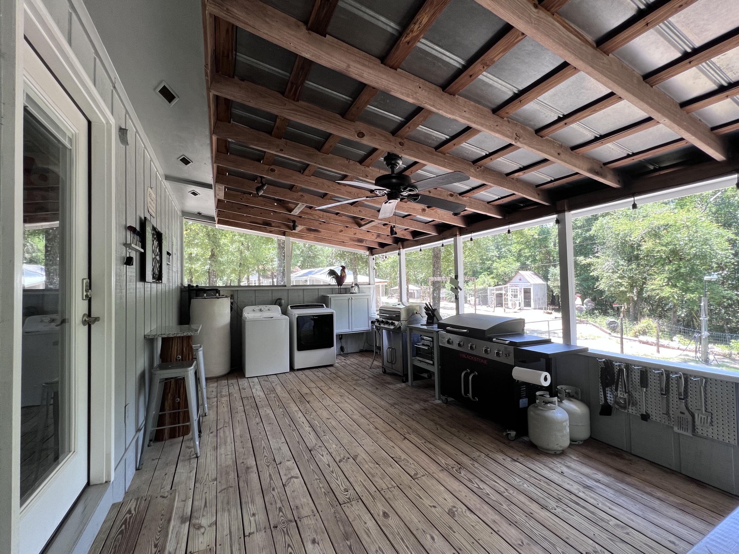 Xxxx Kervin Road Crestview, FL 32539 - Photo 47 of 78 a view of a patio with table and chairs potted plants with wooden floor