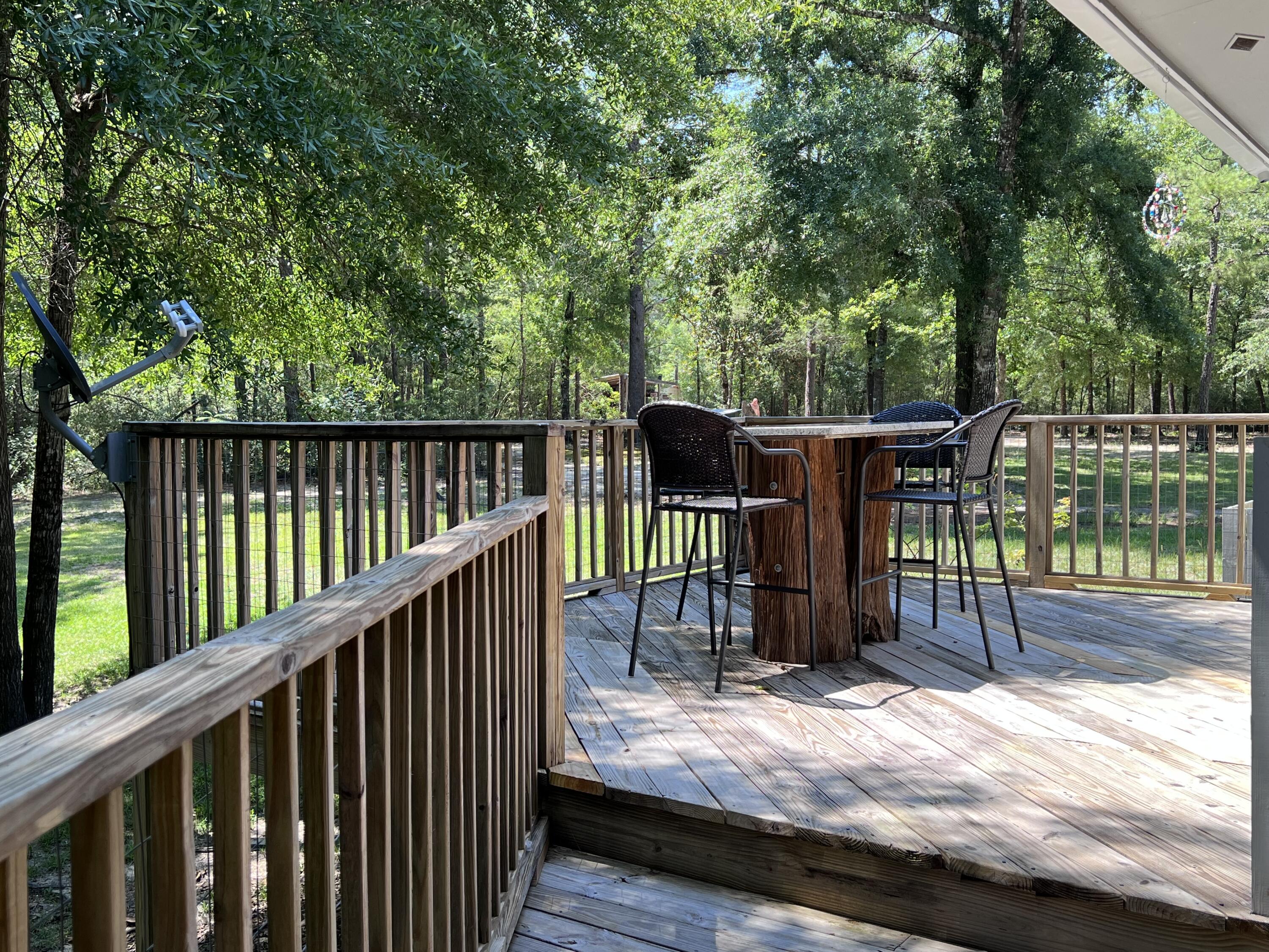 Xxxx Kervin Road Crestview, FL 32539 - Photo 54 of 78 a view of deck with wooden floor and outdoor seating