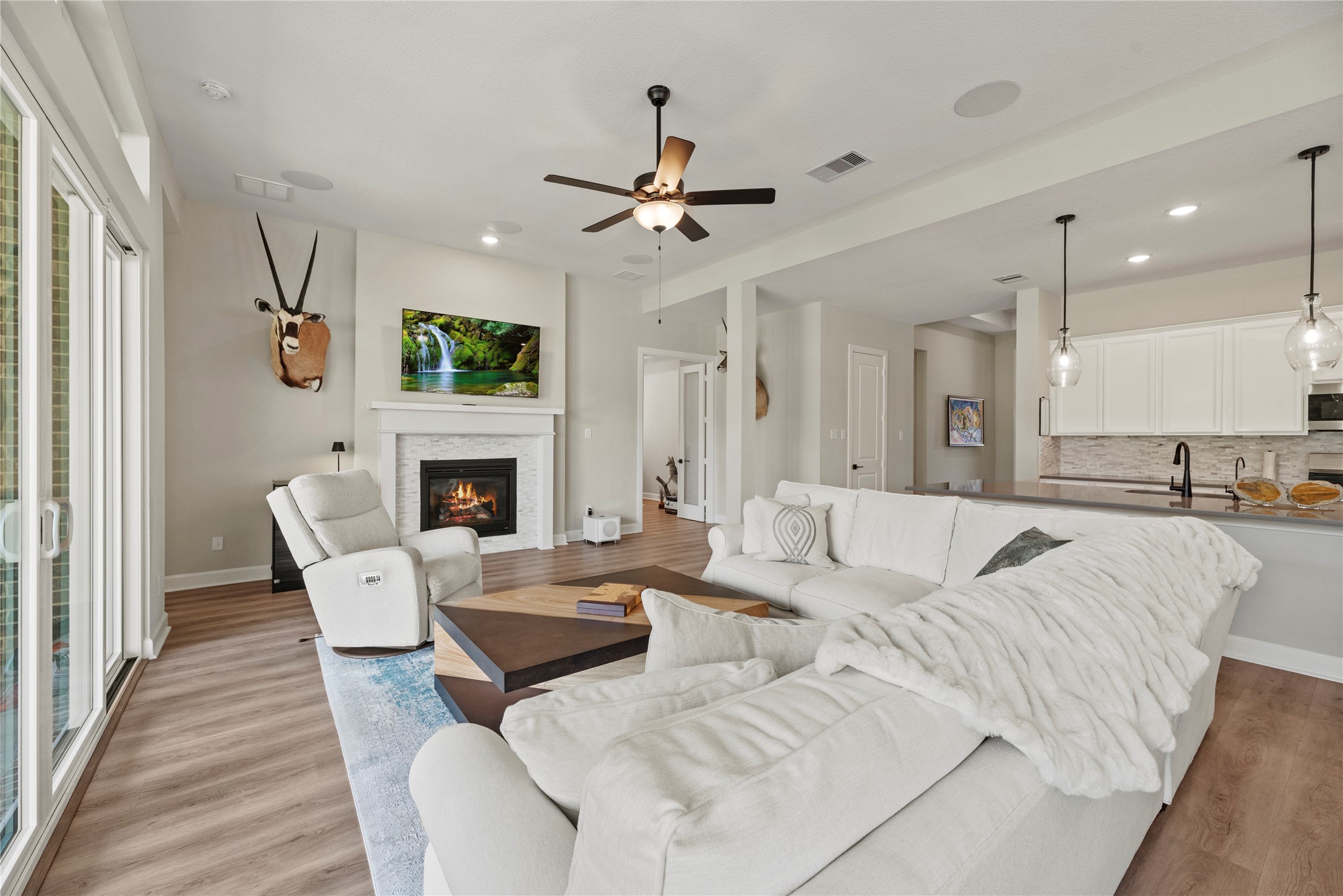 7543 Congress Trail Way Porter, TX 77365 - Photo 11 of 45 a living room with furniture a fireplace and a flat screen tv