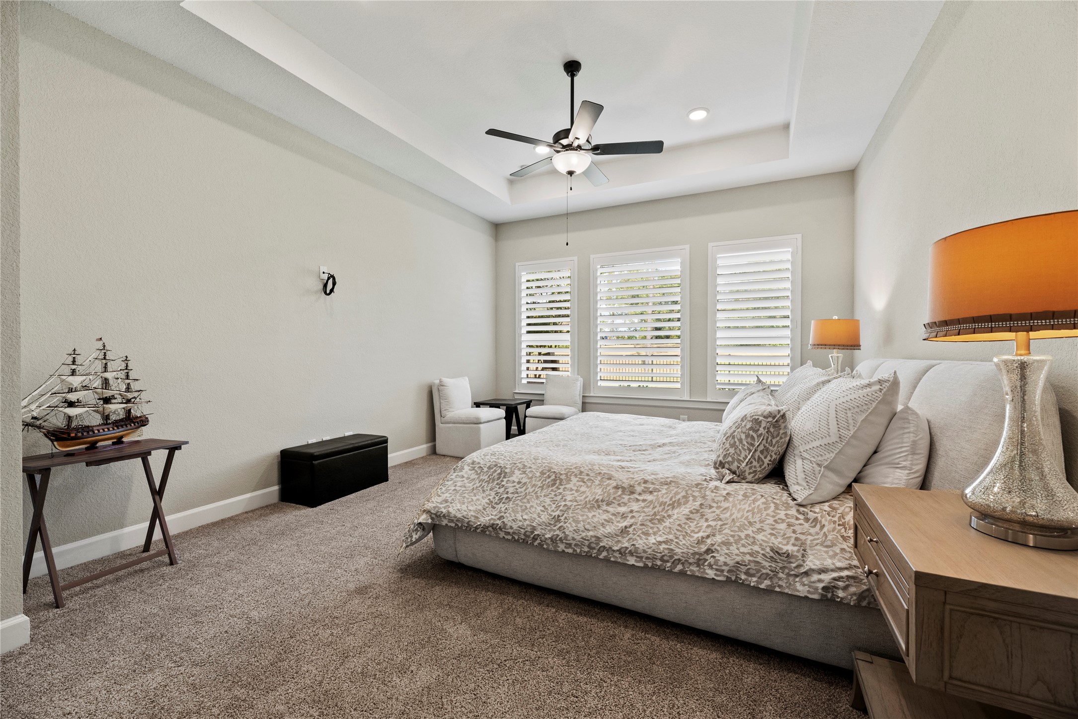 7543 Congress Trail Way Porter, TX 77365 - Photo 20 of 45 a bedroom with a bed and a chandelier