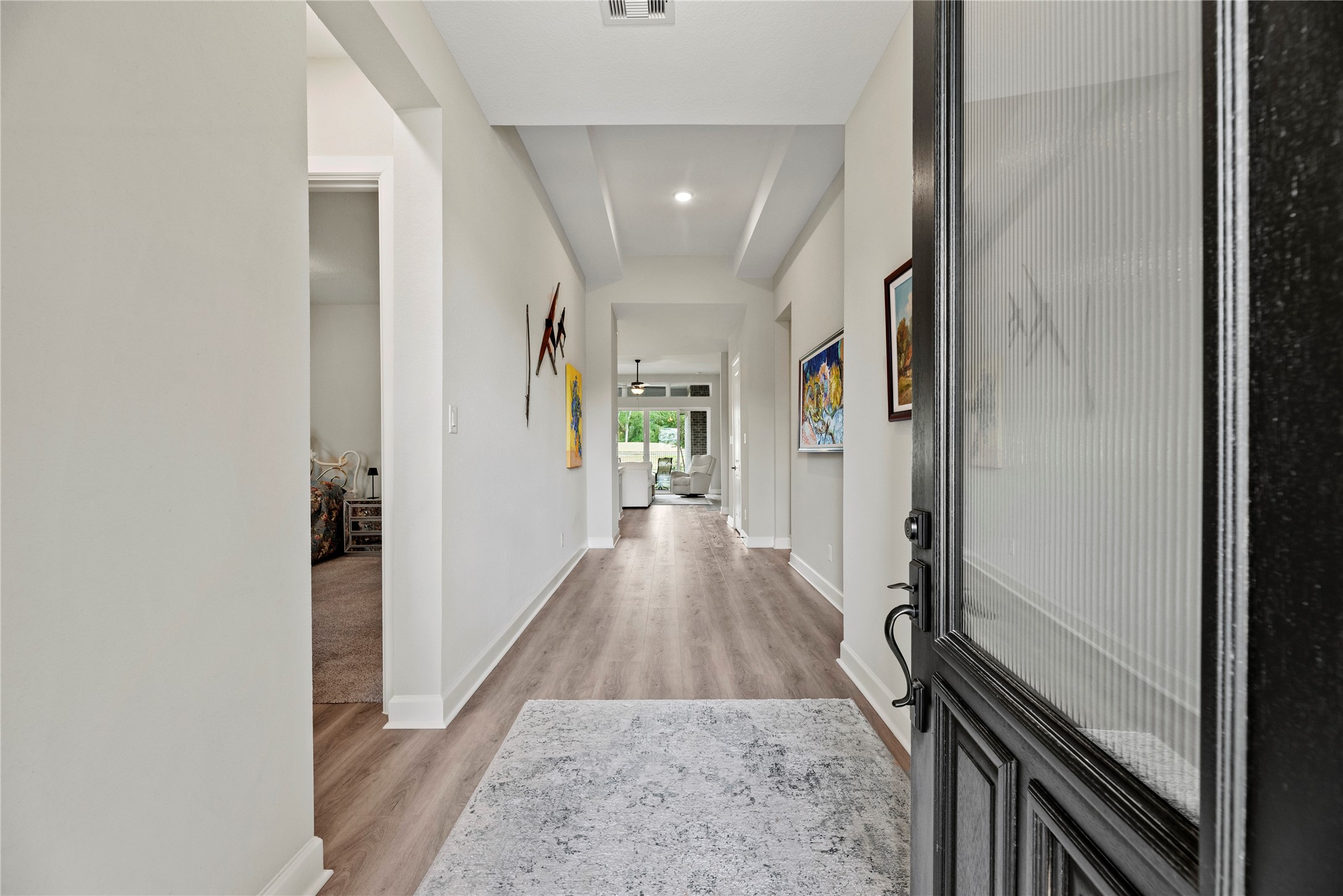 7543 Congress Trail Way Porter, TX 77365 - Photo 6 of 45 a view of a hallway with wooden floor and staircase