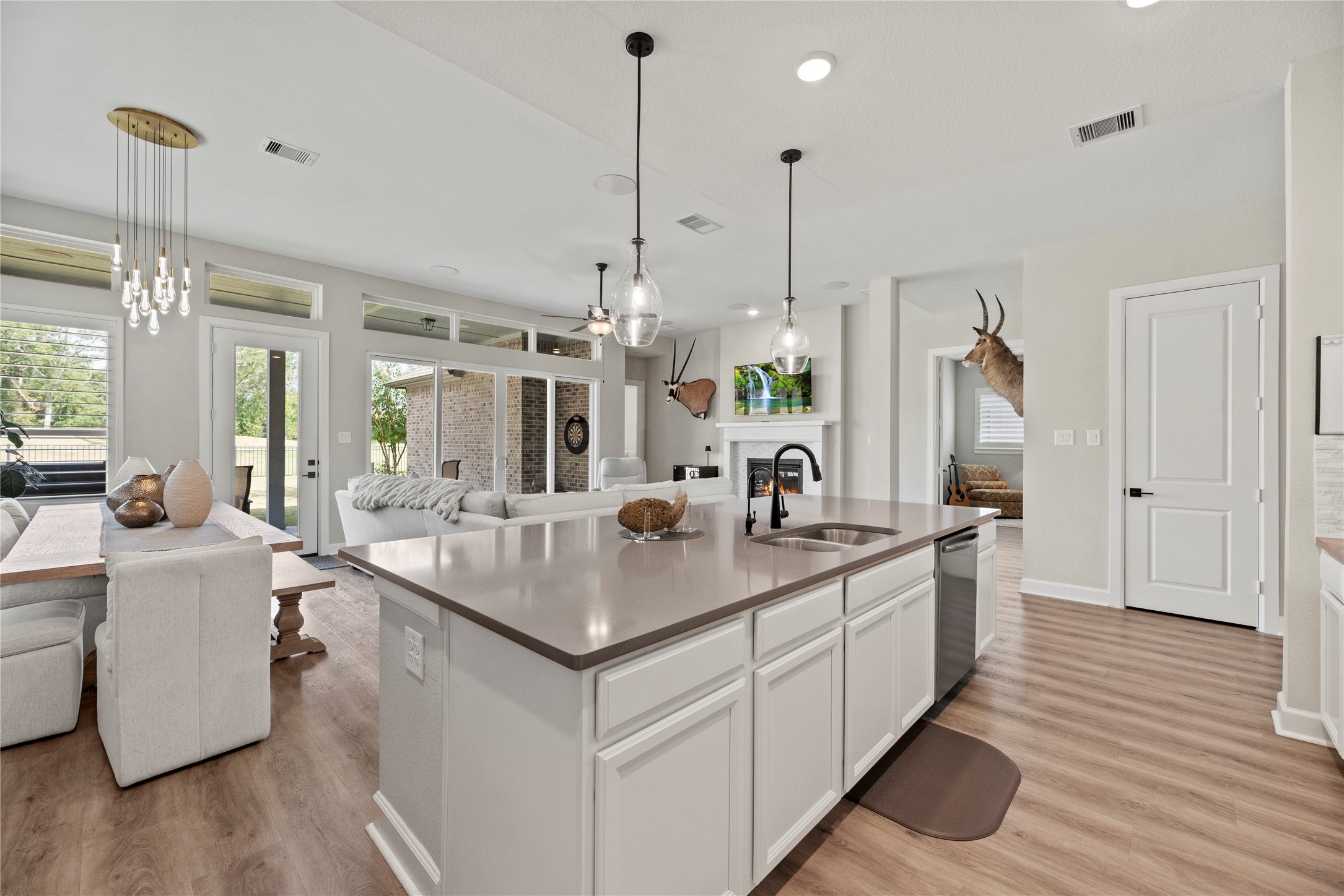 7543 Congress Trail Way Porter, TX 77365 - Photo 8 of 45 a kitchen with kitchen island a sink stove and wooden floor