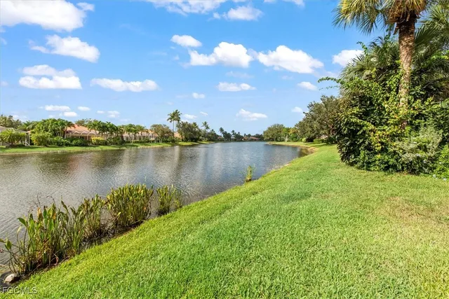 a view of a lake with houses in the back