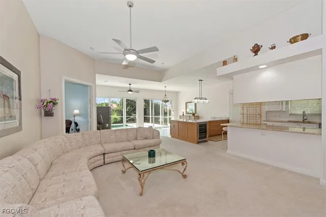 a living room with furniture and kitchen view