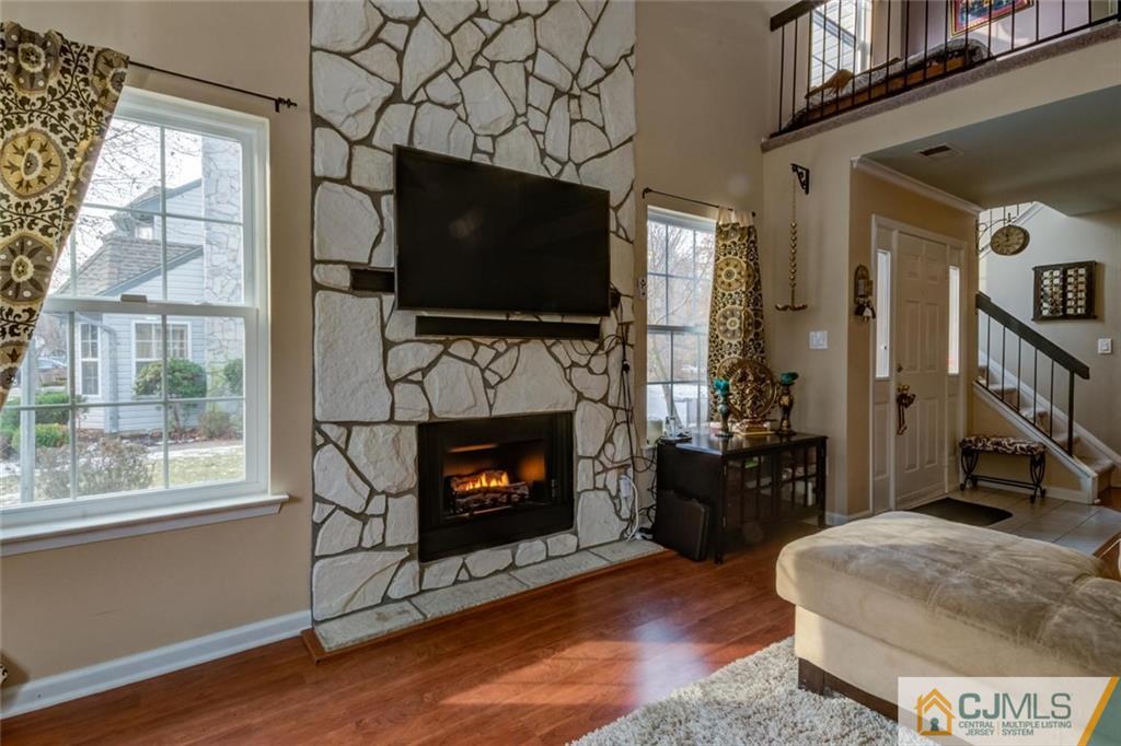 191 Nebula Road, Unit 191 Piscataway, NJ 08854 - Photo 11 of 24 a living room with furniture a flat screen tv and a fireplace