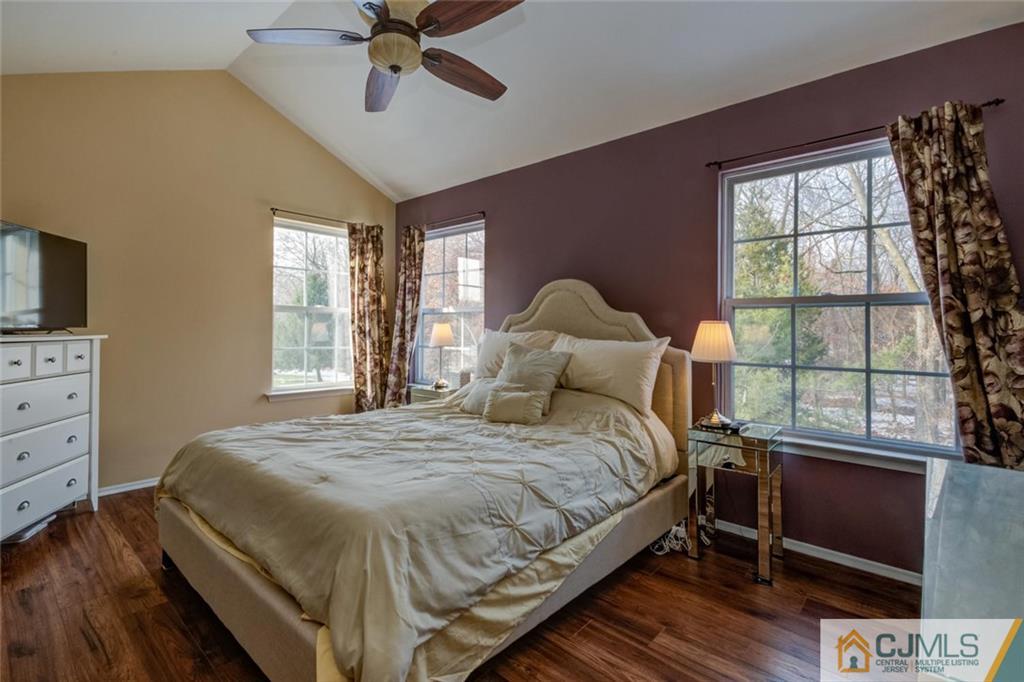 191 Nebula Road, Unit 191 Piscataway, NJ 08854 - Photo 13 of 24 a bedroom with a bed and a flat tv screen on dresser