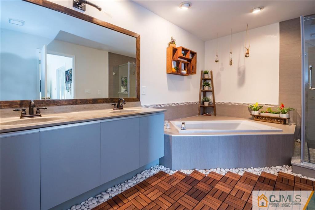 191 Nebula Road, Unit 191 Piscataway, NJ 08854 - Photo 14 of 24 a bathroom with a tub a sink and a mirror