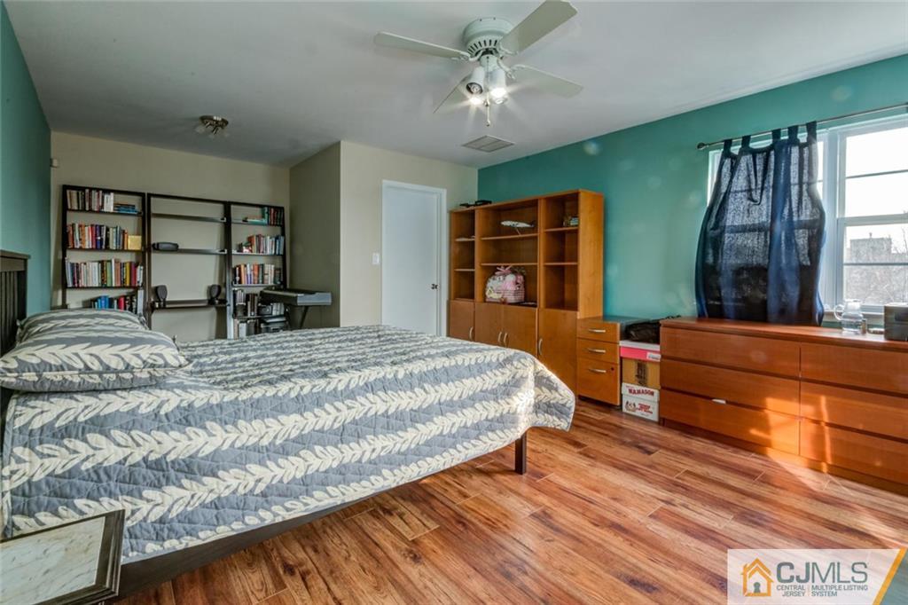 191 Nebula Road, Unit 191 Piscataway, NJ 08854 - Photo 17 of 24 a bed sitting in a bedroom next to a window