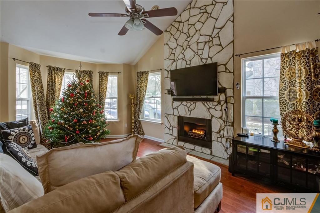 191 Nebula Road, Unit 191 Piscataway, NJ 08854 - Photo 19 of 24 a living room with furniture a flat screen tv and a fireplace