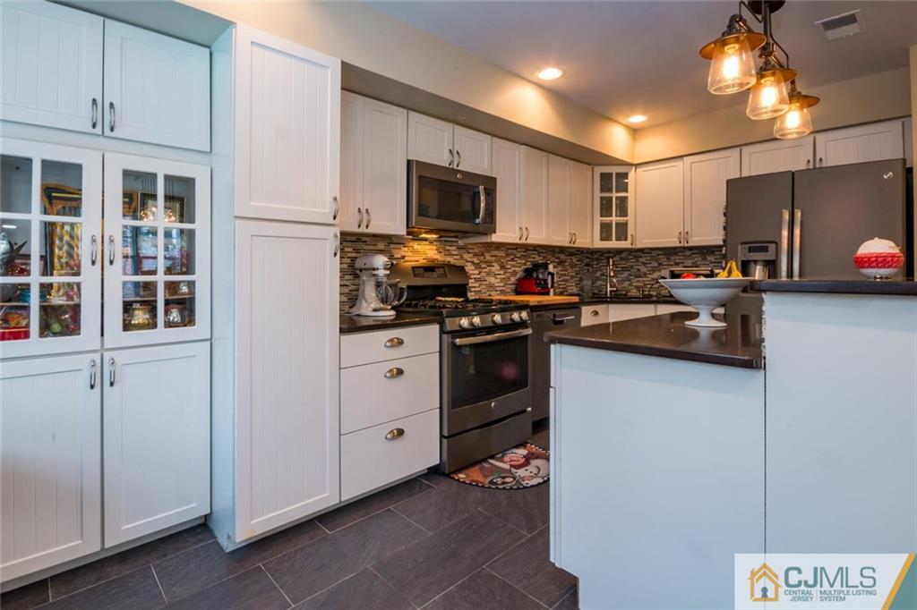 191 Nebula Road, Unit 191 Piscataway, NJ 08854 - Photo 4 of 24 a kitchen with cabinets a sink and appliances