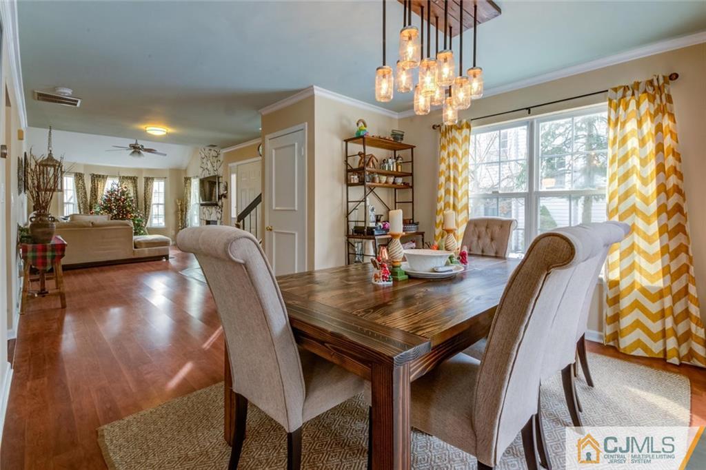 191 Nebula Road, Unit 191 Piscataway, NJ 08854 - Photo 9 of 24 a view of a dining room with furniture window and wooden floor