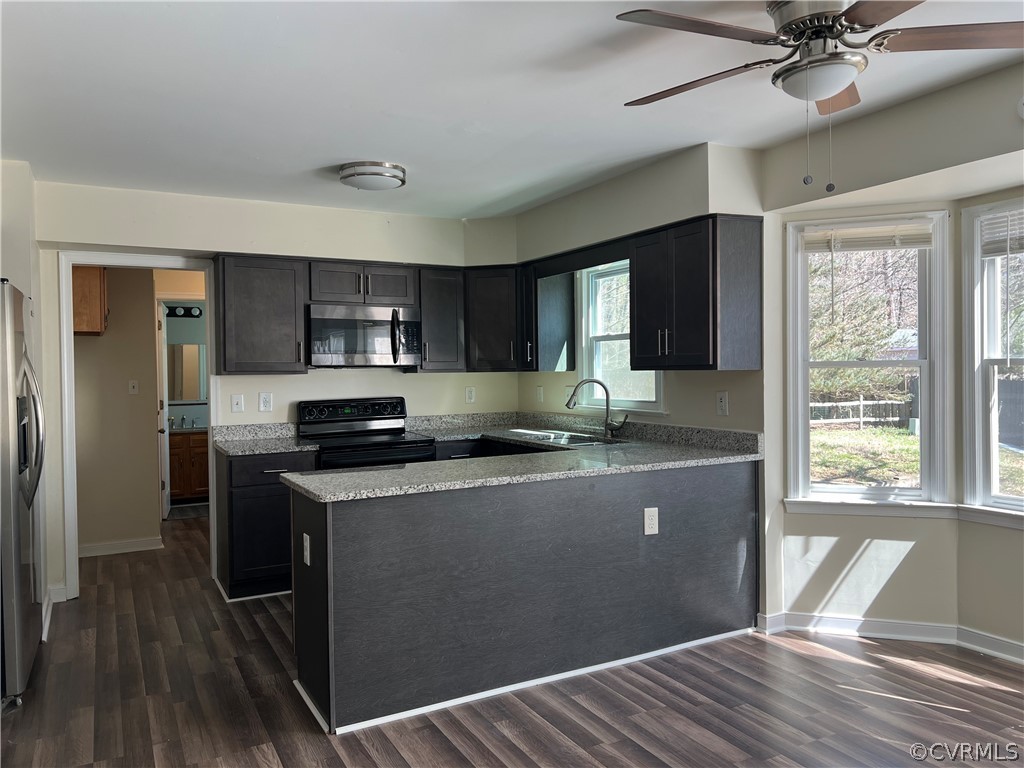 2525 Retrievers Ridge Road Richmond, VA 23233 - Photo 17 of 49 a kitchen with kitchen island granite countertop a sink cabinets and wooden floor