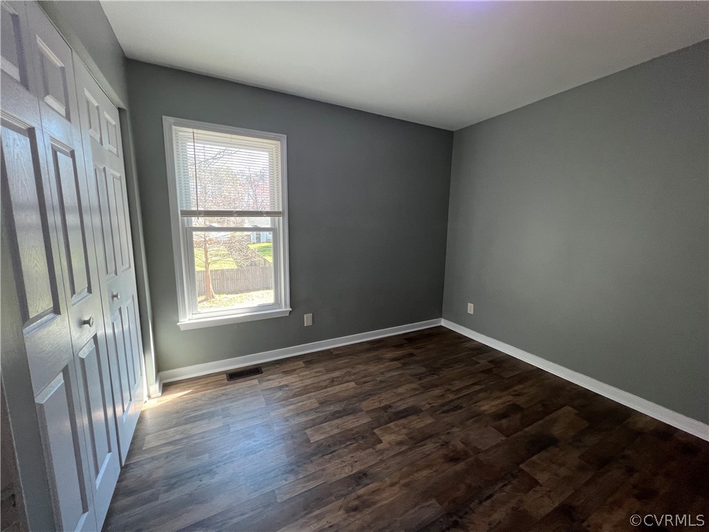 2525 Retrievers Ridge Road Richmond, VA 23233 - Photo 32 of 49 an empty room with wooden floor and windows