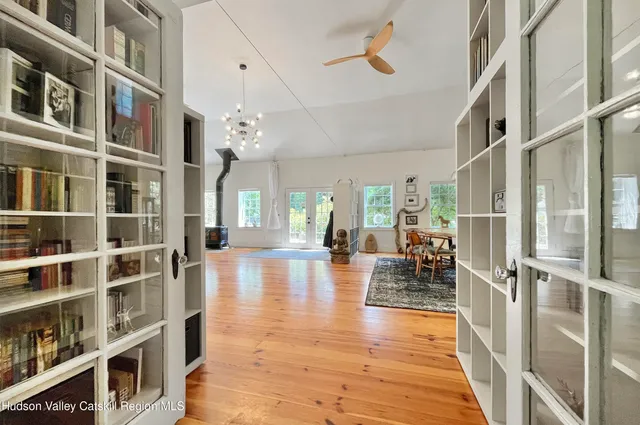 a view of a living room with furniture and wooden floor