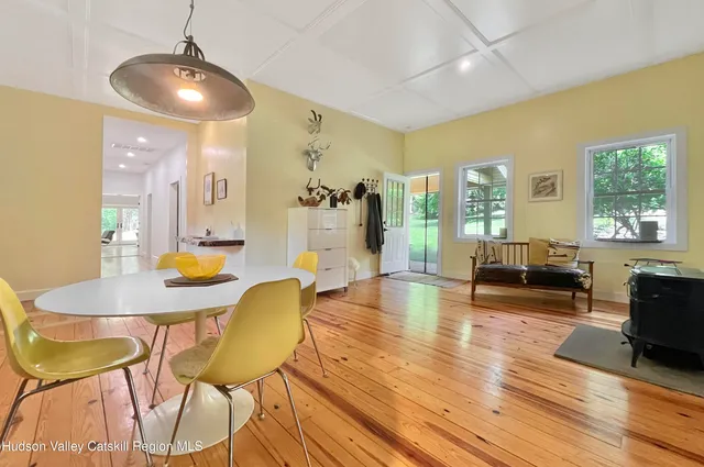 a large kitchen with stainless steel appliances a large window a oven a counter space and a window