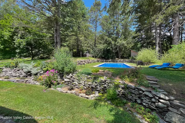 a view of a fire pit with large trees