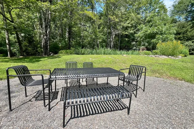 a view of a garden with plants and large trees