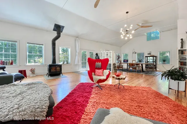 a living room with furniture kitchen view and a chandelier