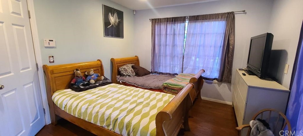 2478 Colorado Boulevard Eagle Rock, CA 90041 - Photo 13 of 14 a bedroom with a bed and a flat tv screen on the dresser