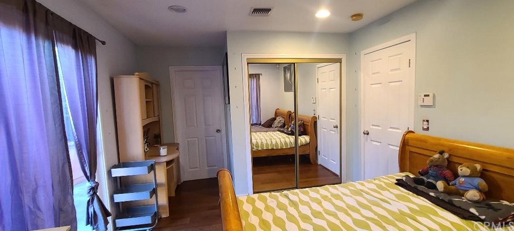 2478 Colorado Boulevard Eagle Rock, CA 90041 - Photo 7 of 14 a bedroom with a bed and wooden floor