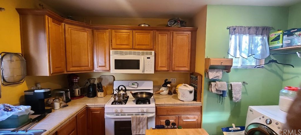2478 Colorado Boulevard Eagle Rock, CA 90041 - Photo 8 of 14 a kitchen with stainless steel appliances granite countertop a stove top oven a sink and cabinets